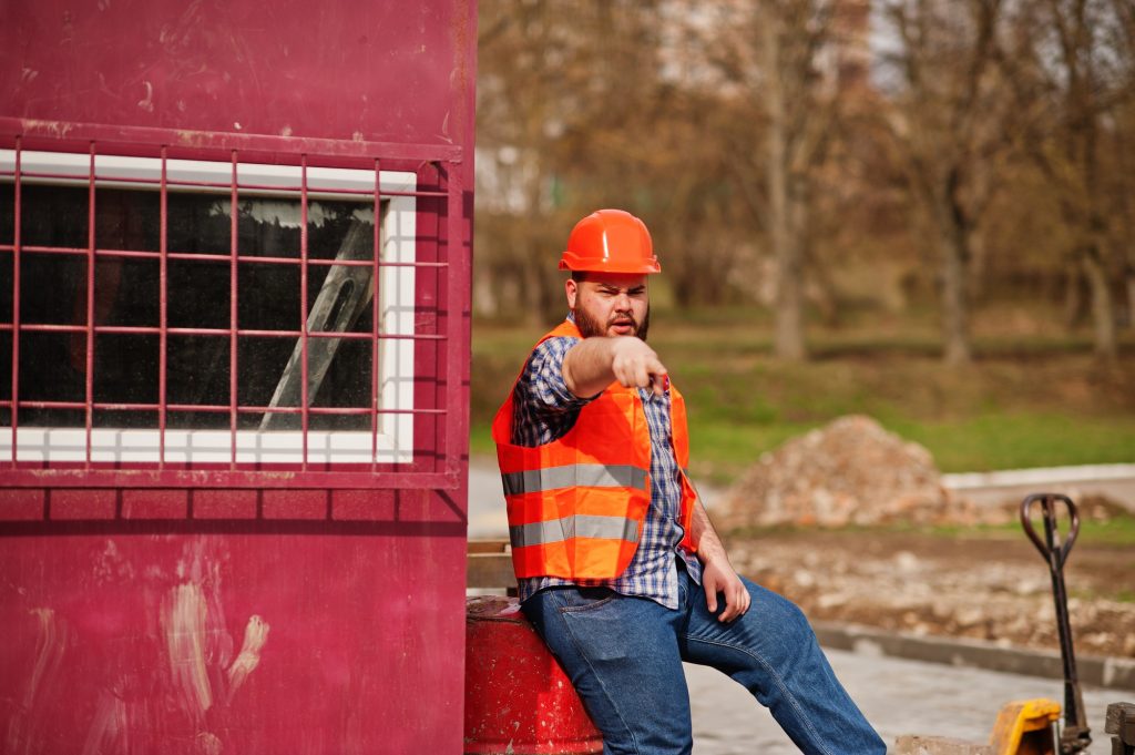 Beard worker man suit construction worker in safety orange helmet